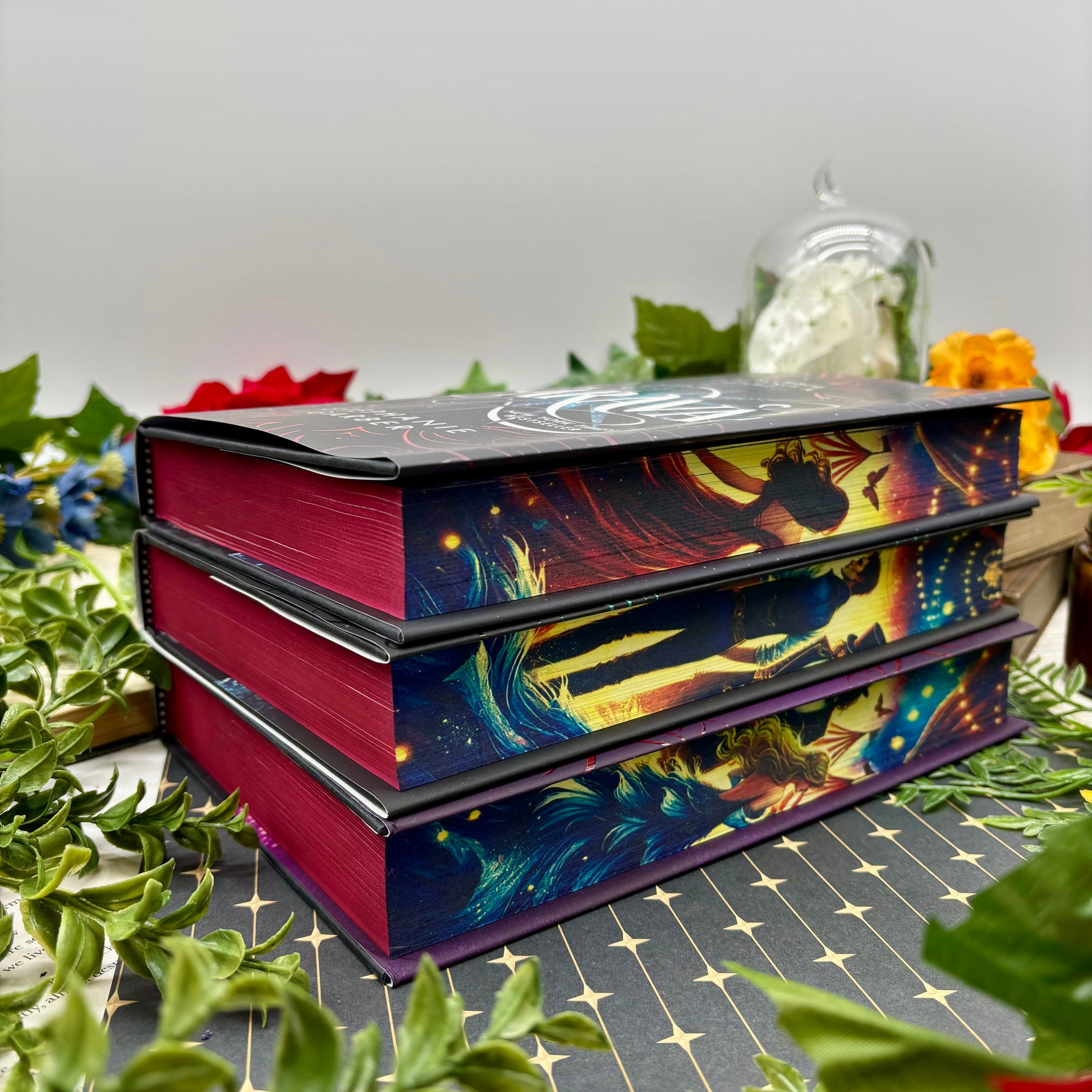 Stack of Caraval, Legendary, and Finale special editions with custom sprayed edges