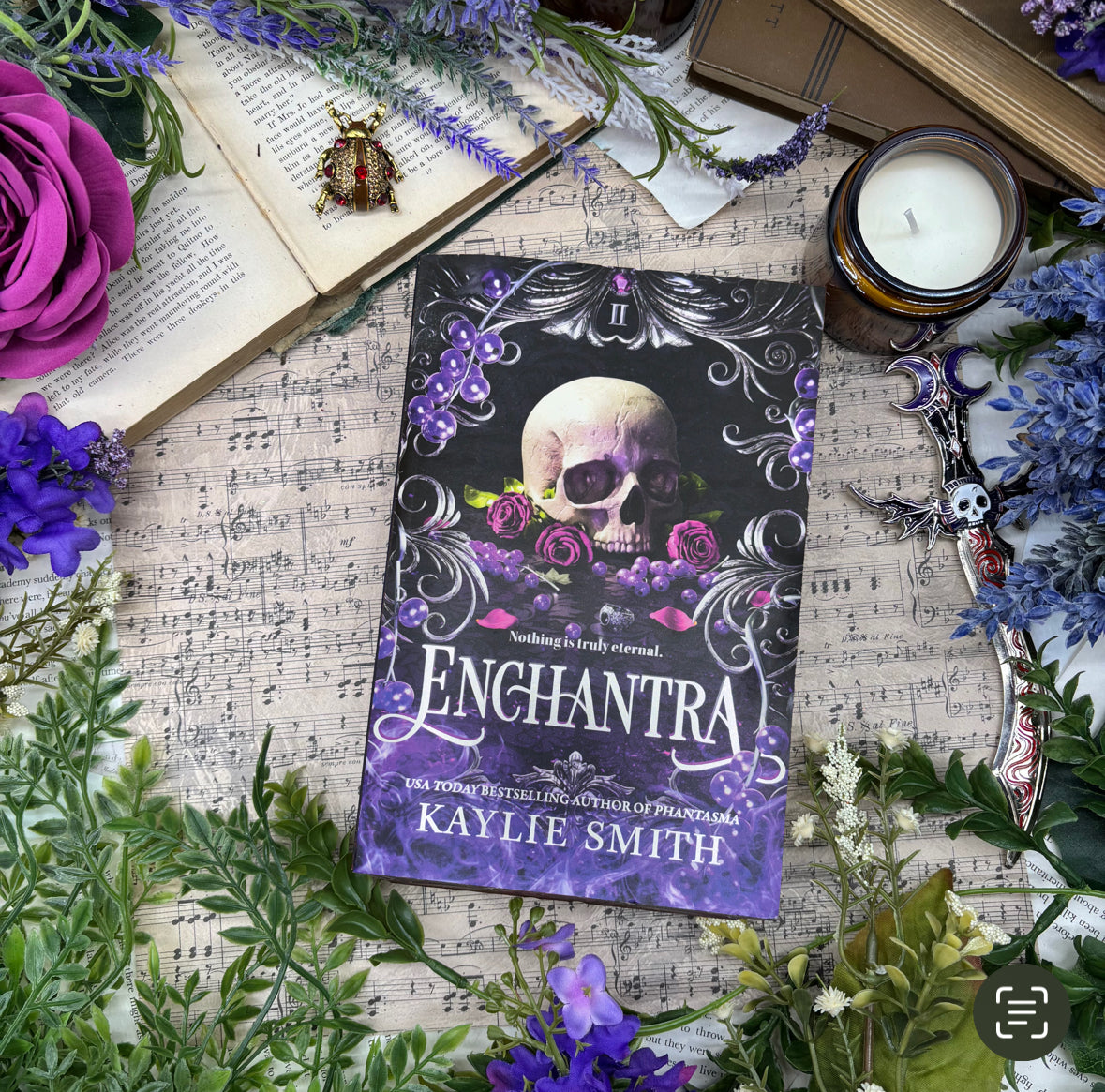 Front cover of Enchantra special edition paperback by Kaylie Smith with skull and rose edge design