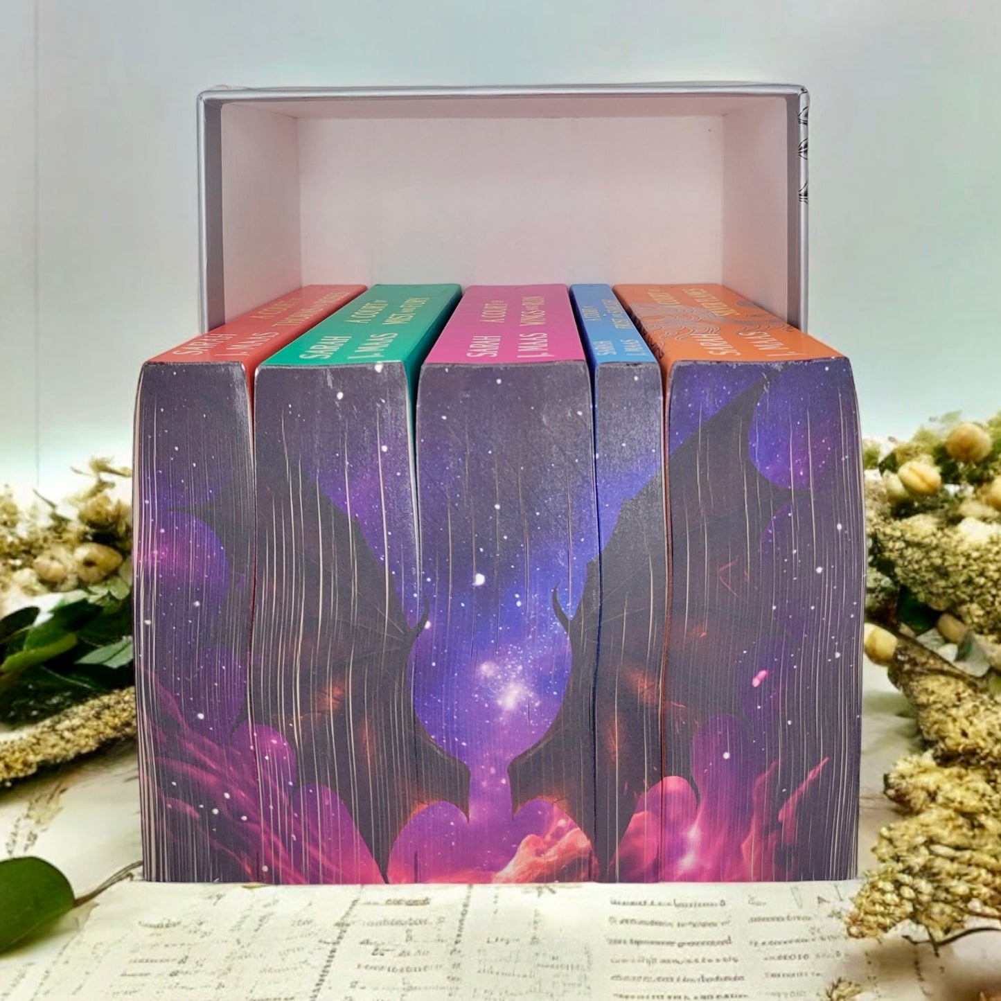 Close-up of night sky and bat wings sprayed edges on ACOTAR Velaris Edition paperbacks