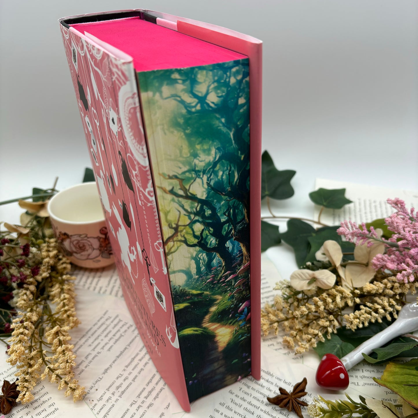 Custom sprayed edges on Alice in Wonderland special edition with Wonderland-inspired art