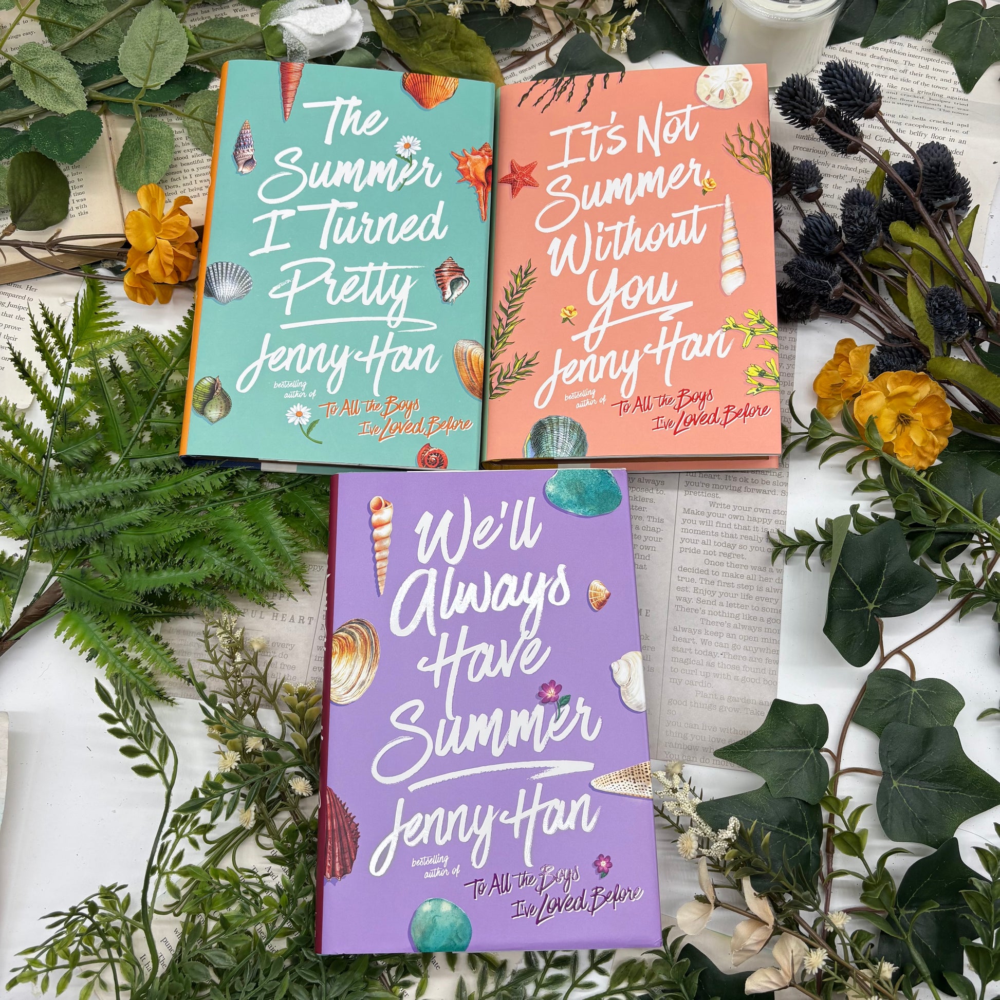 Three books by Jenny Han on a decorative background with greenery and flowers.