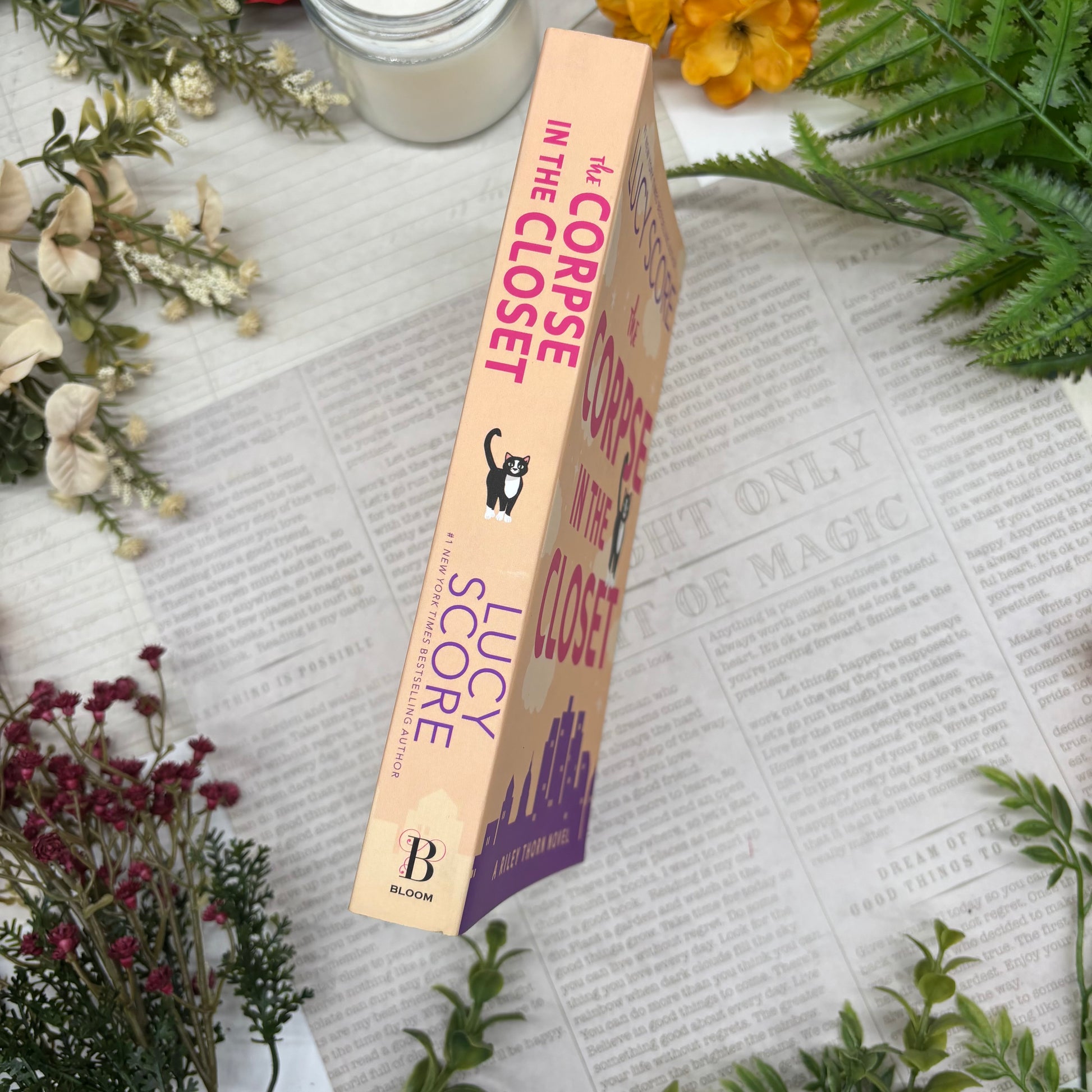 The Corpse in the Closet by Lucy Score special edition paperback with custom designed edges spine view