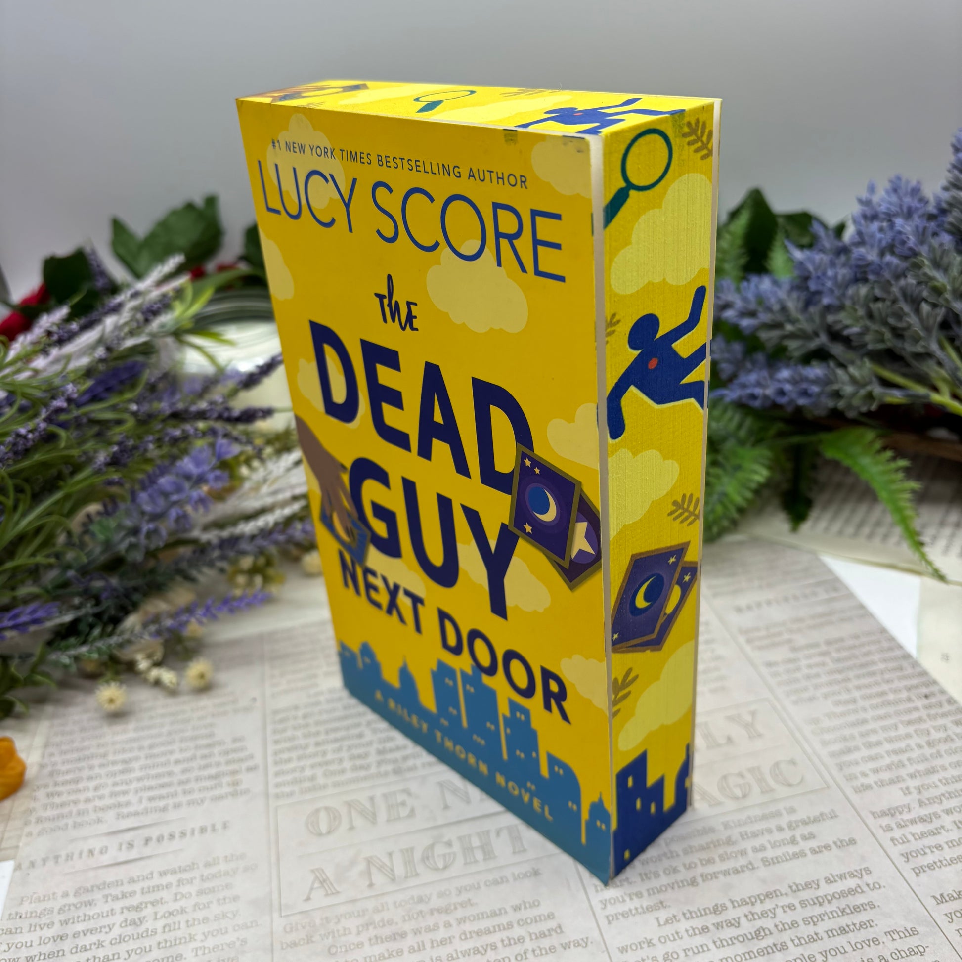 The Dead Guy Next Door by Lucy Score special edition paperback with custom designed edges side view