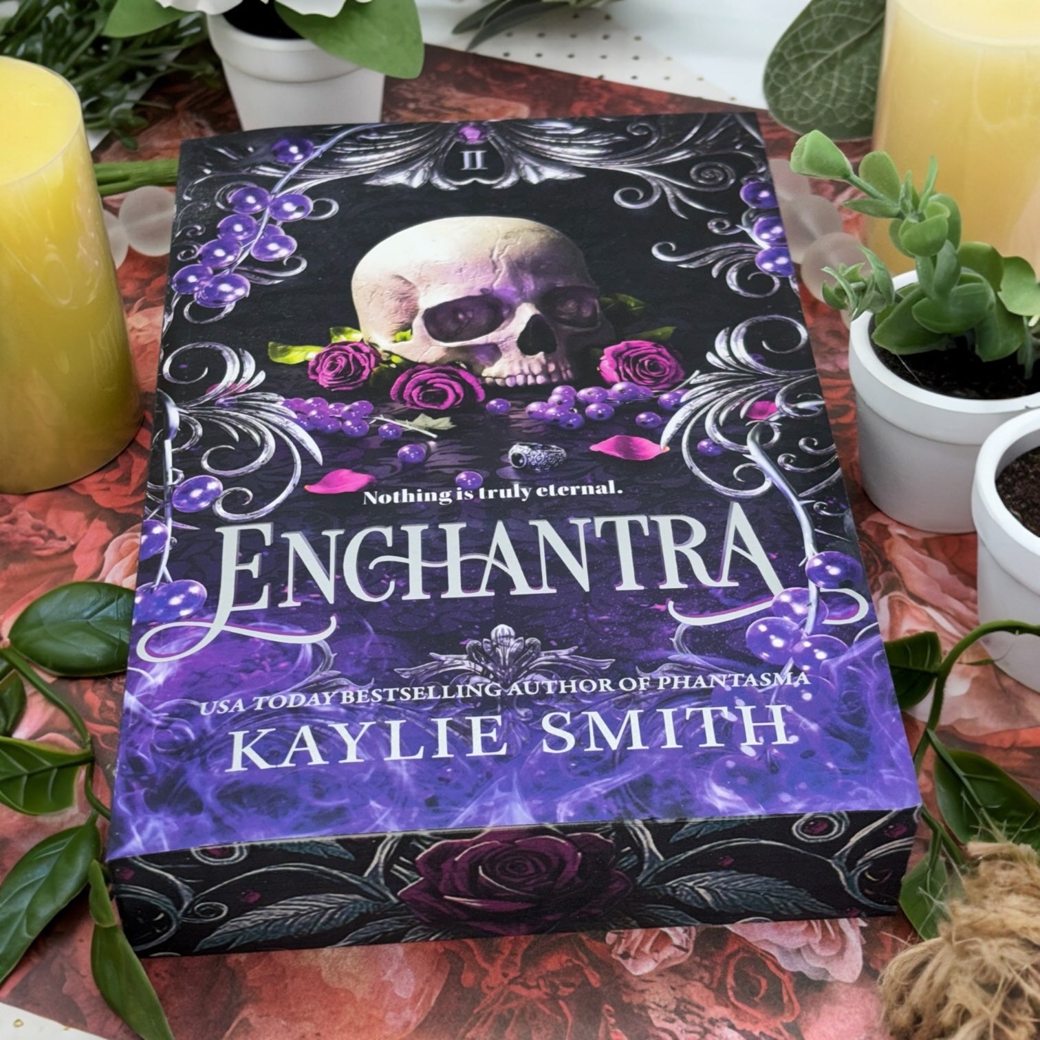 Bottom of Enchantra special edition paperback by Kaylie Smith with skull and rose edge design