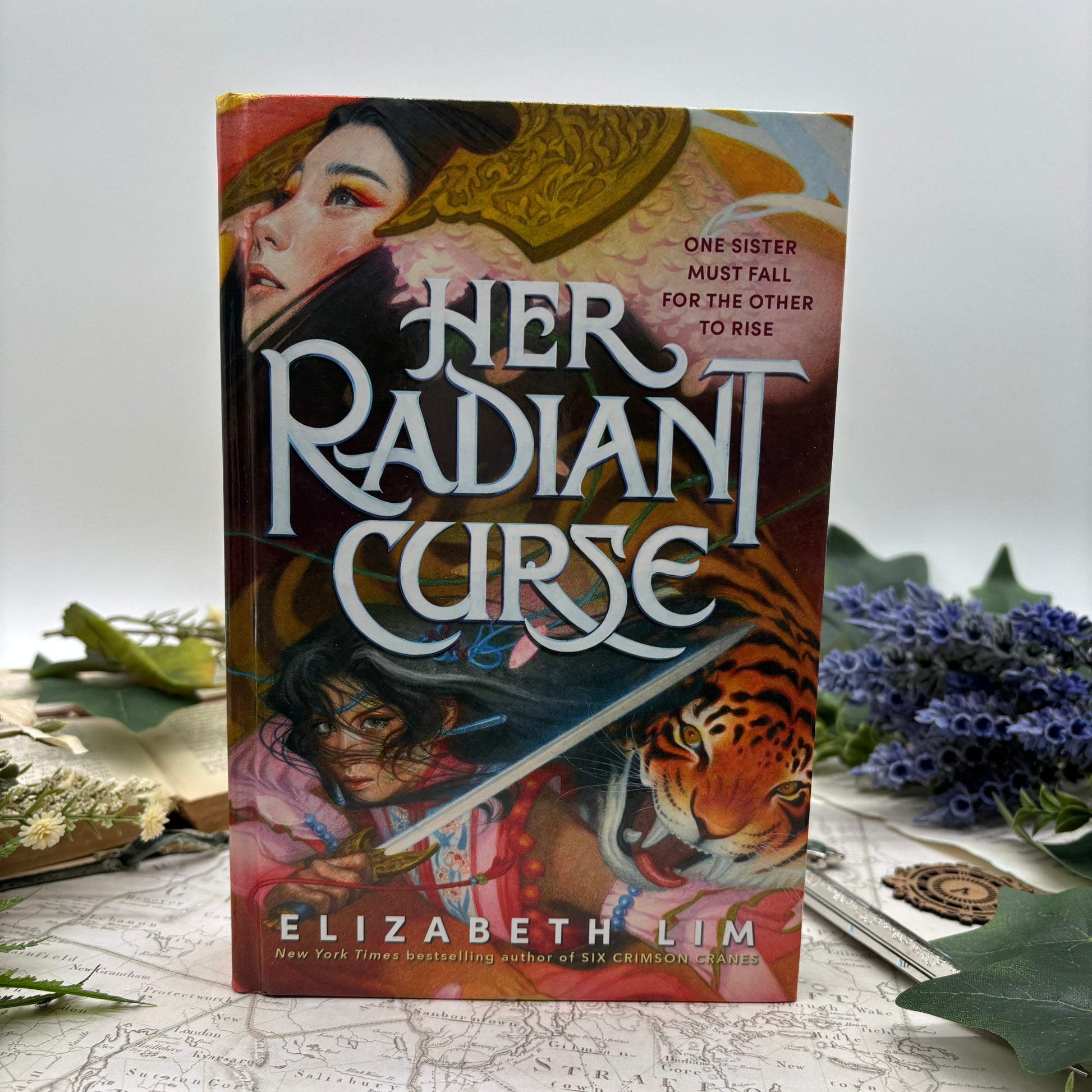 Special edition hardcover of Her Radiant Curse by Elizabeth Lim with stenciled edges