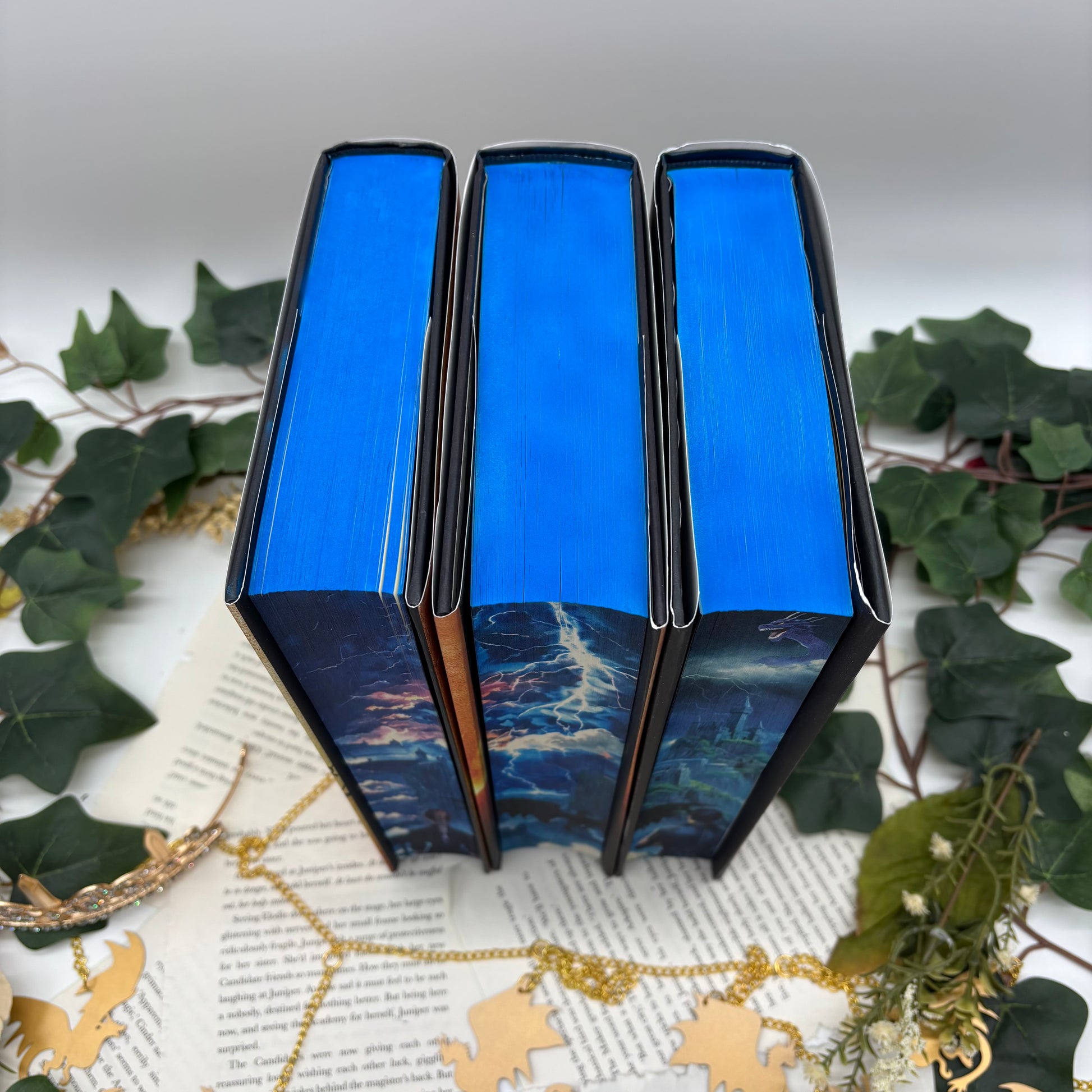 Fourth Wing, Iron Flame, and Onyx Storm special edition hardcovers with sprayed edges tops