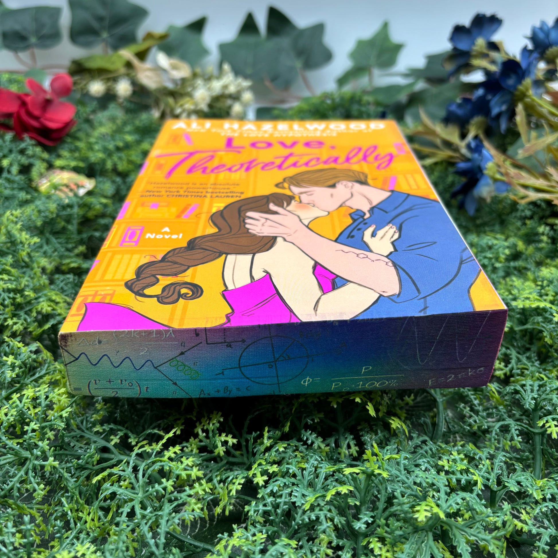 bottom view of Love, Theoretically paperback showing custom sprayed edges special edition