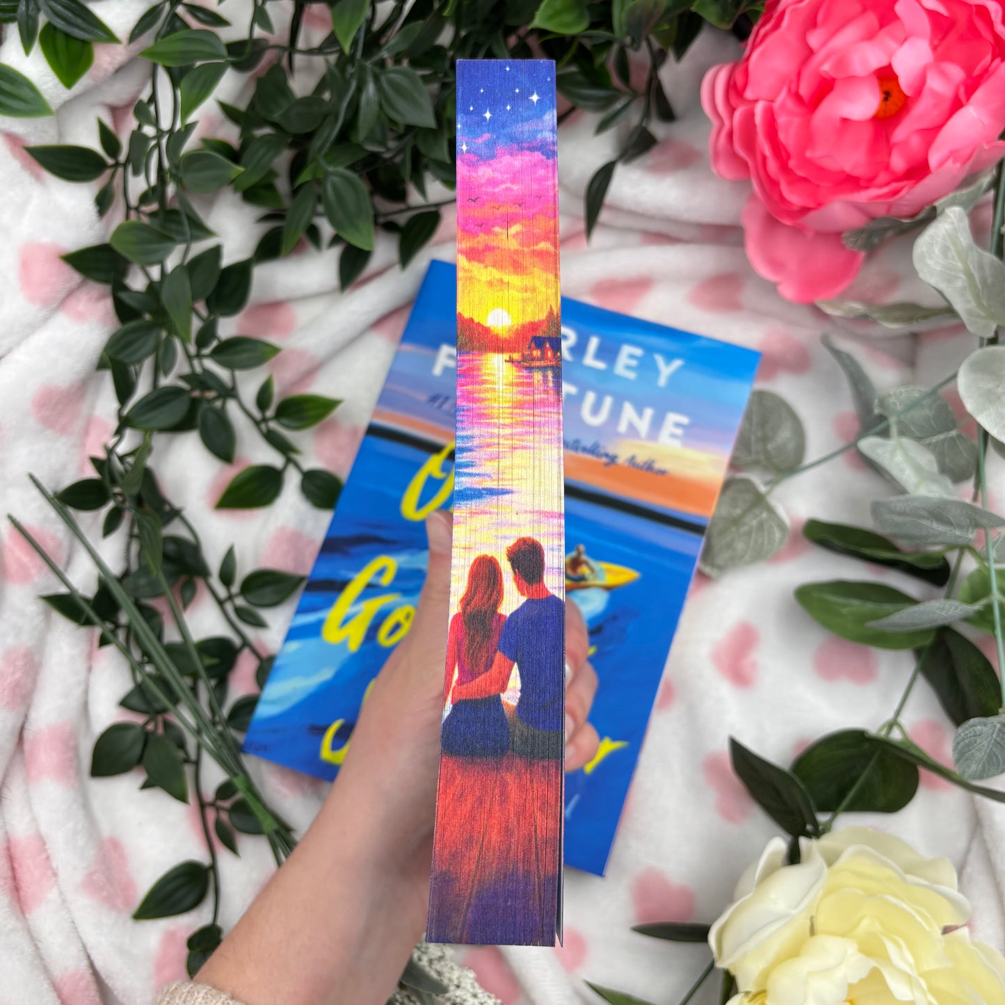 close up of custom sprayed edges on One Golden Summer by Carley Fortune special edition paperback
