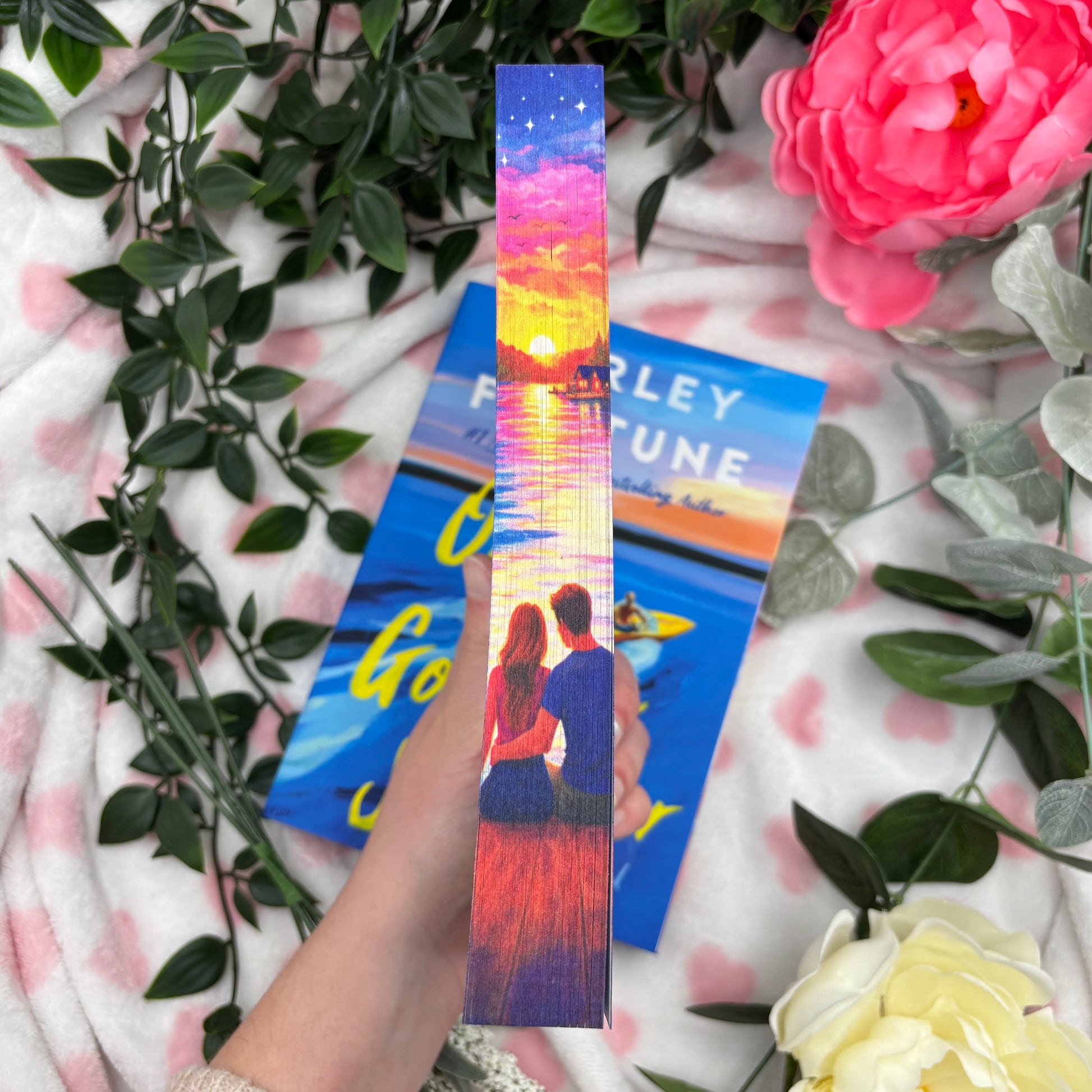 close up of custom sprayed edges on One Golden Summer by Carley Fortune special edition paperback