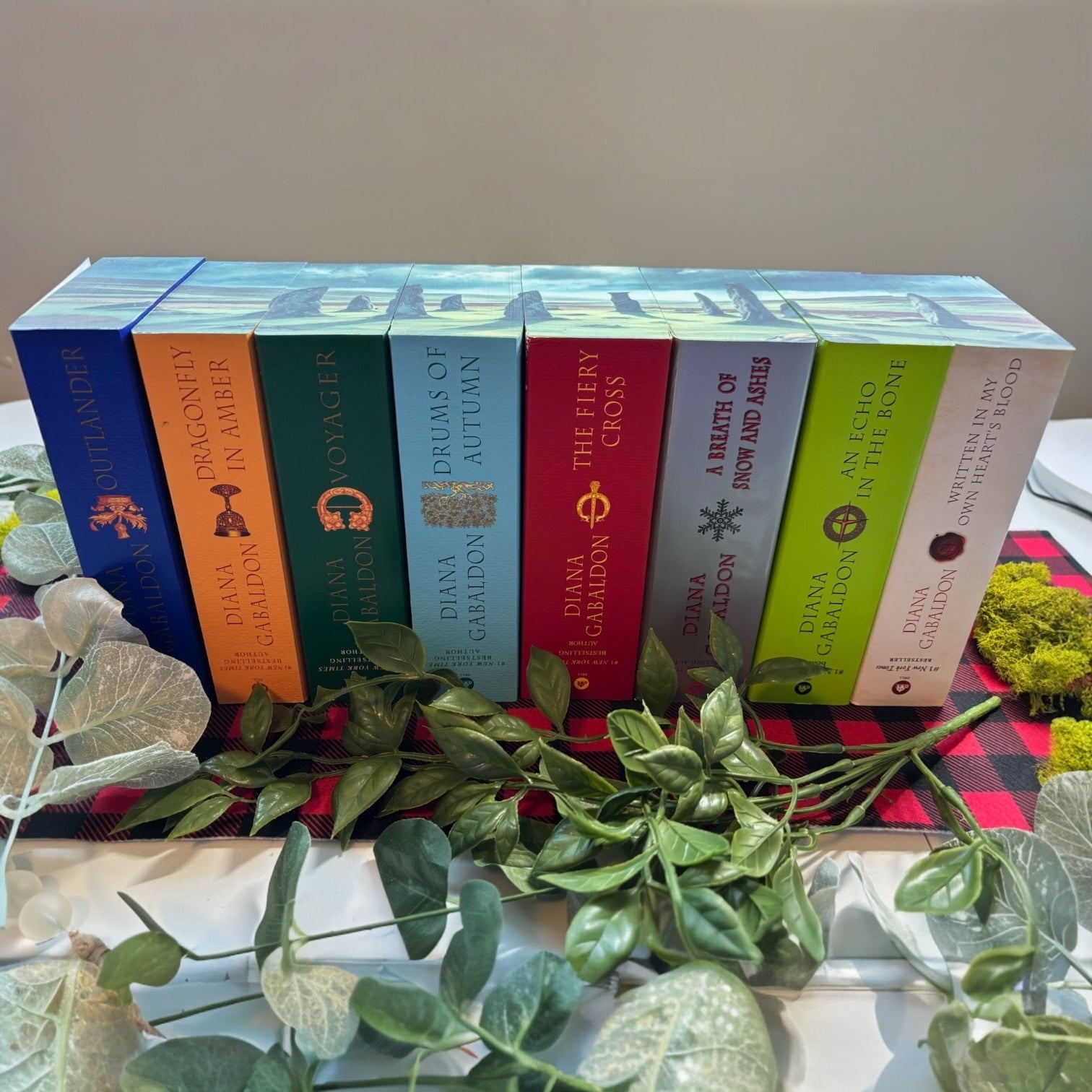 Custom-edged Outlander books stacked togethe