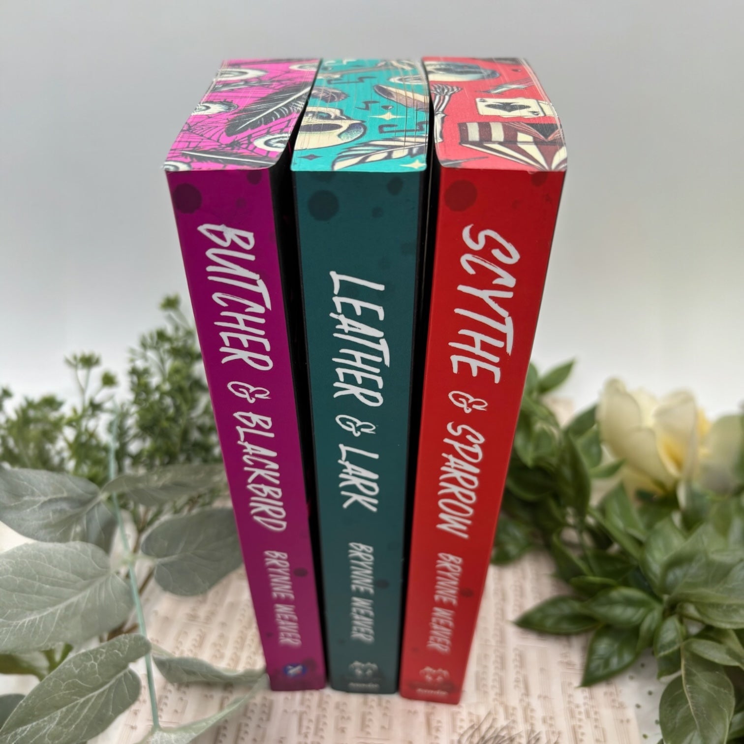 Spine view of custom edge painted books from Ruinous Love Trilogy special edition