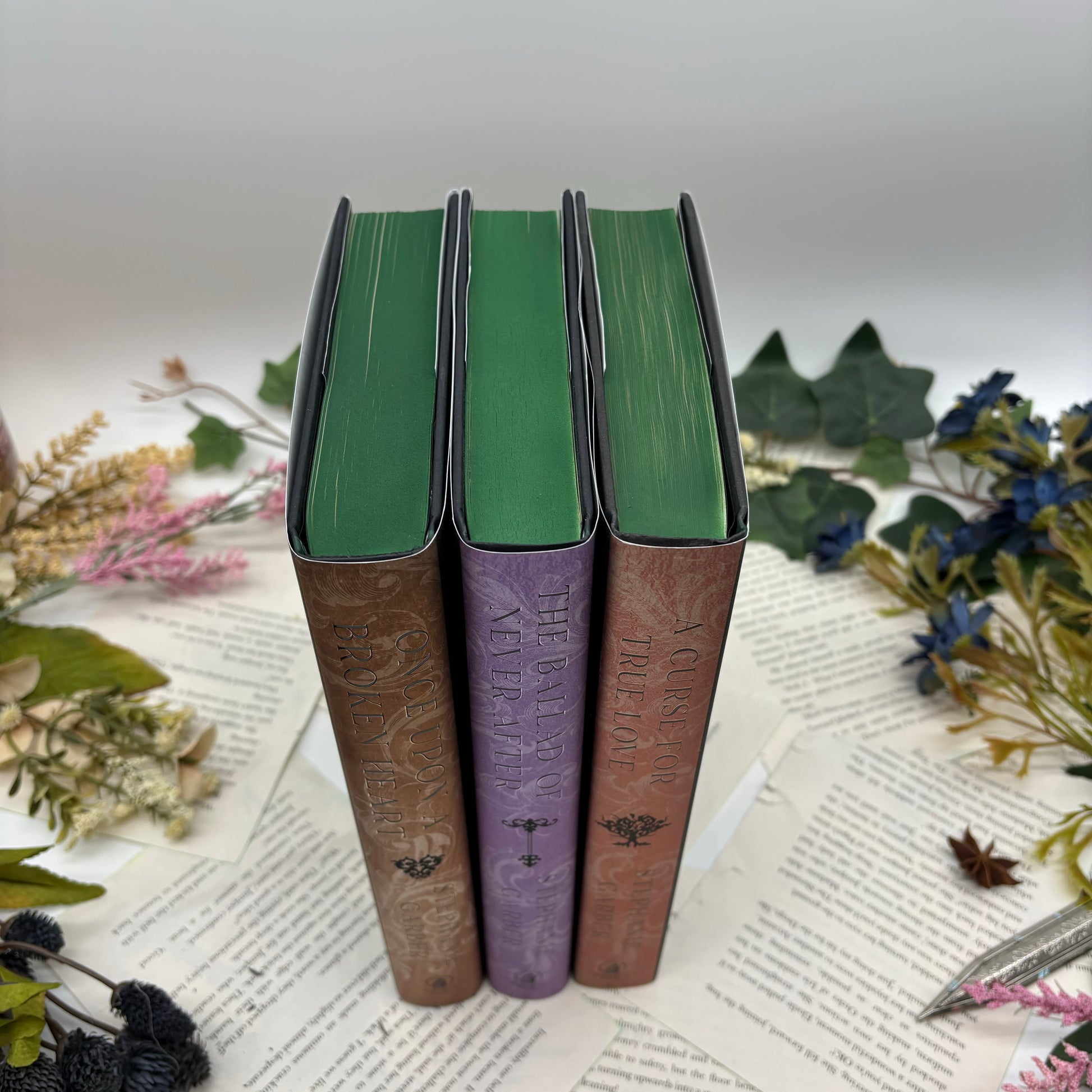 Top view of the Once Upon a Broken Heart trilogy with hand-airbrushed edges