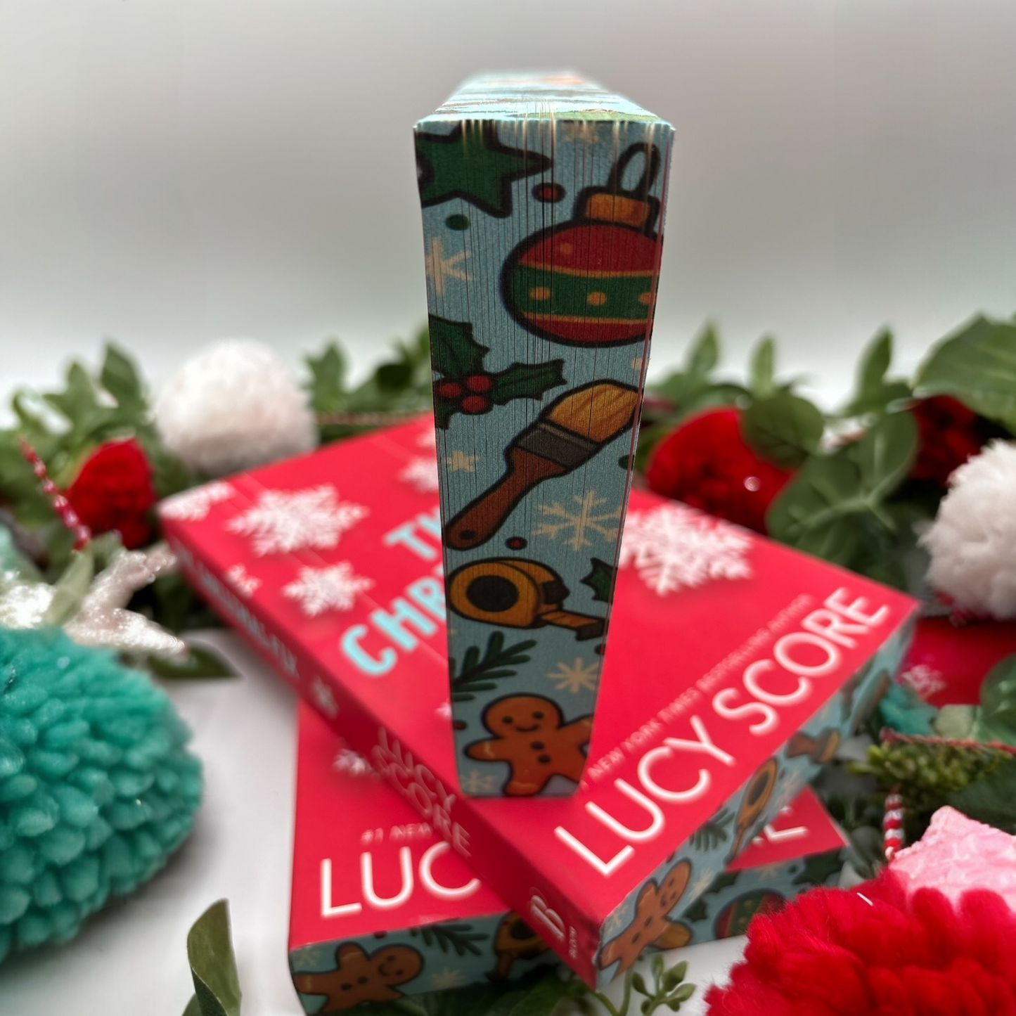 The Christmas Fix by Lucy Score special edition paperback with holiday custom edges bottom view