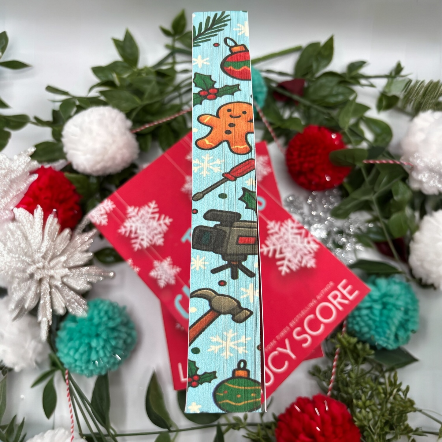 The Christmas Fix by Lucy Score special edition paperback with holiday custom edges middle view