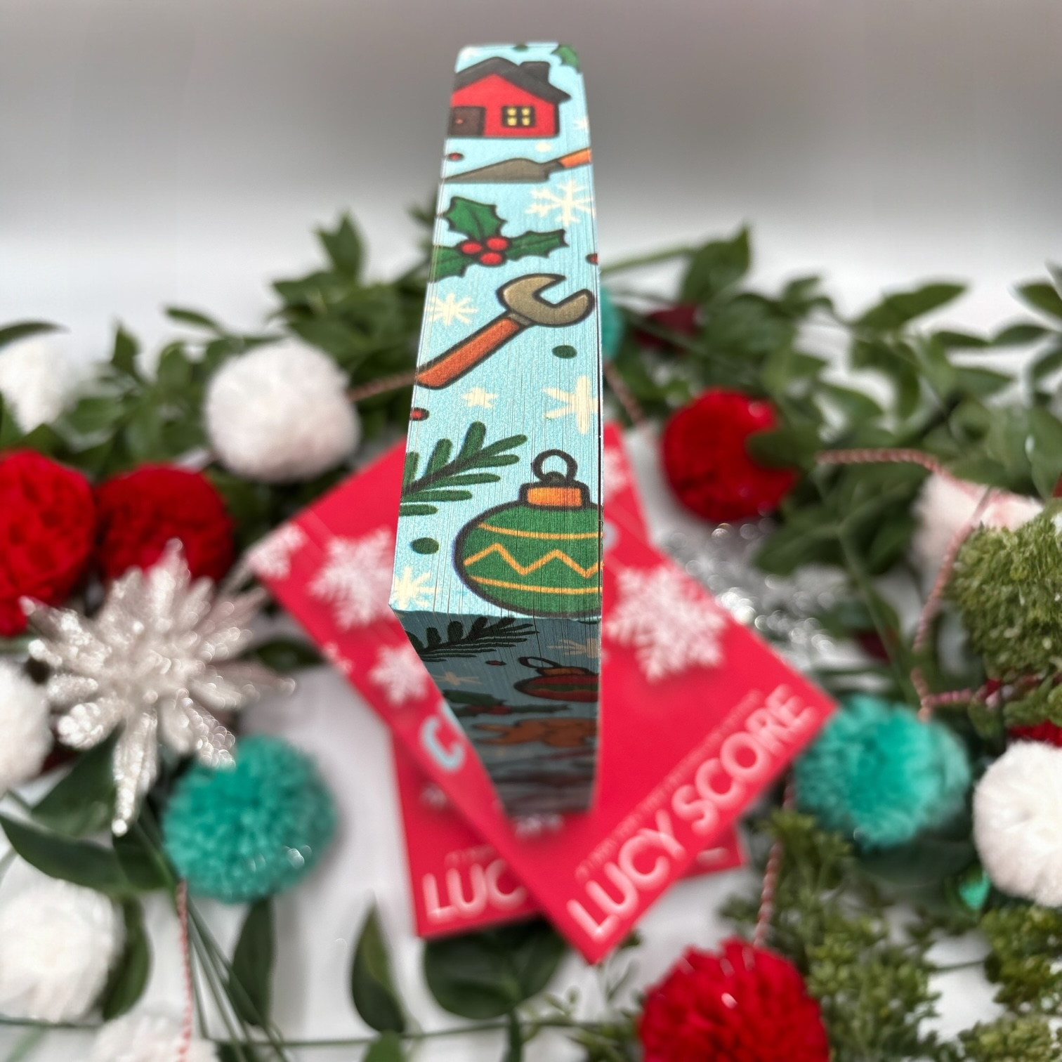 The Christmas Fix by Lucy Score special edition paperback with holiday custom edges top view