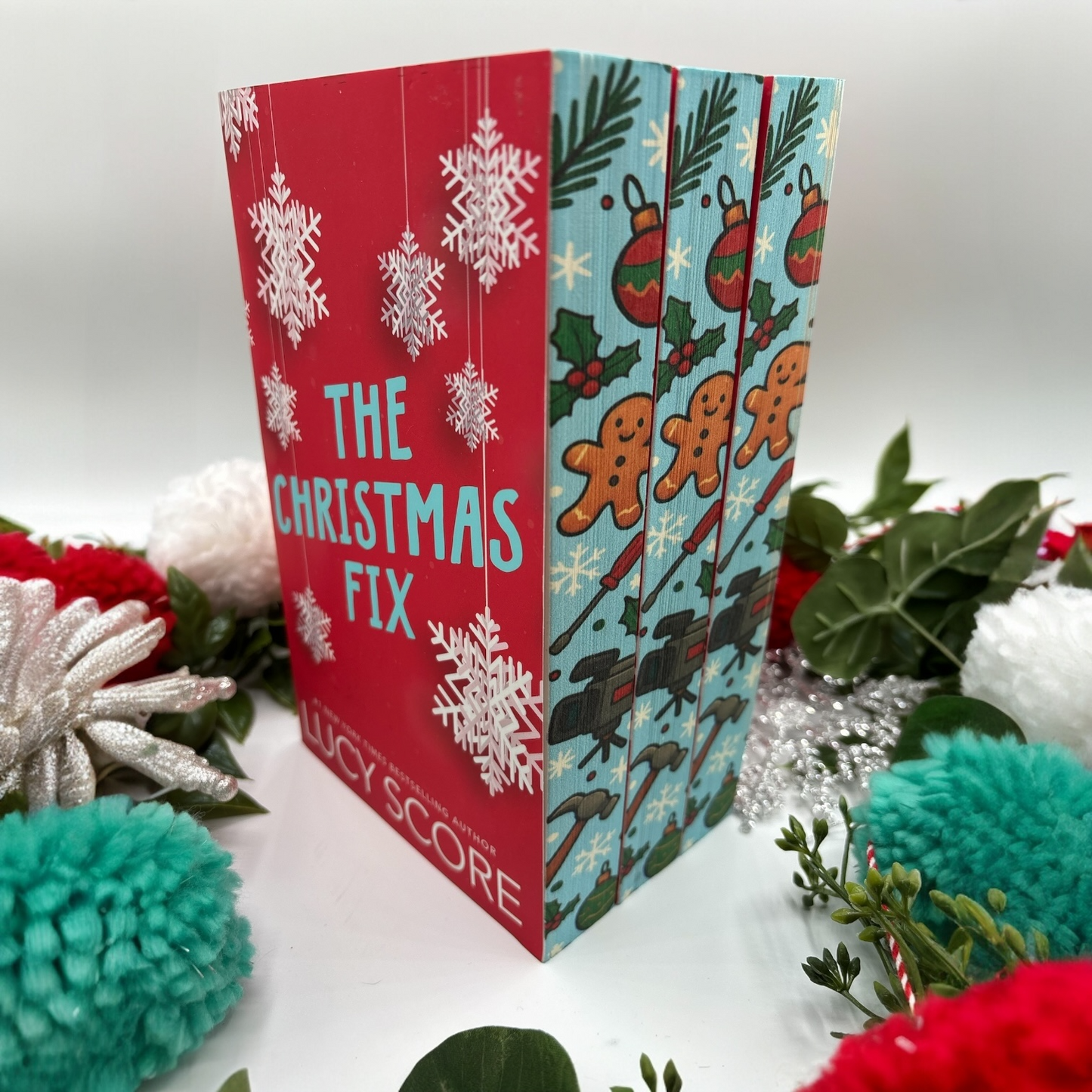The Christmas Fix by Lucy Score special edition paperback with holiday custom edges front view