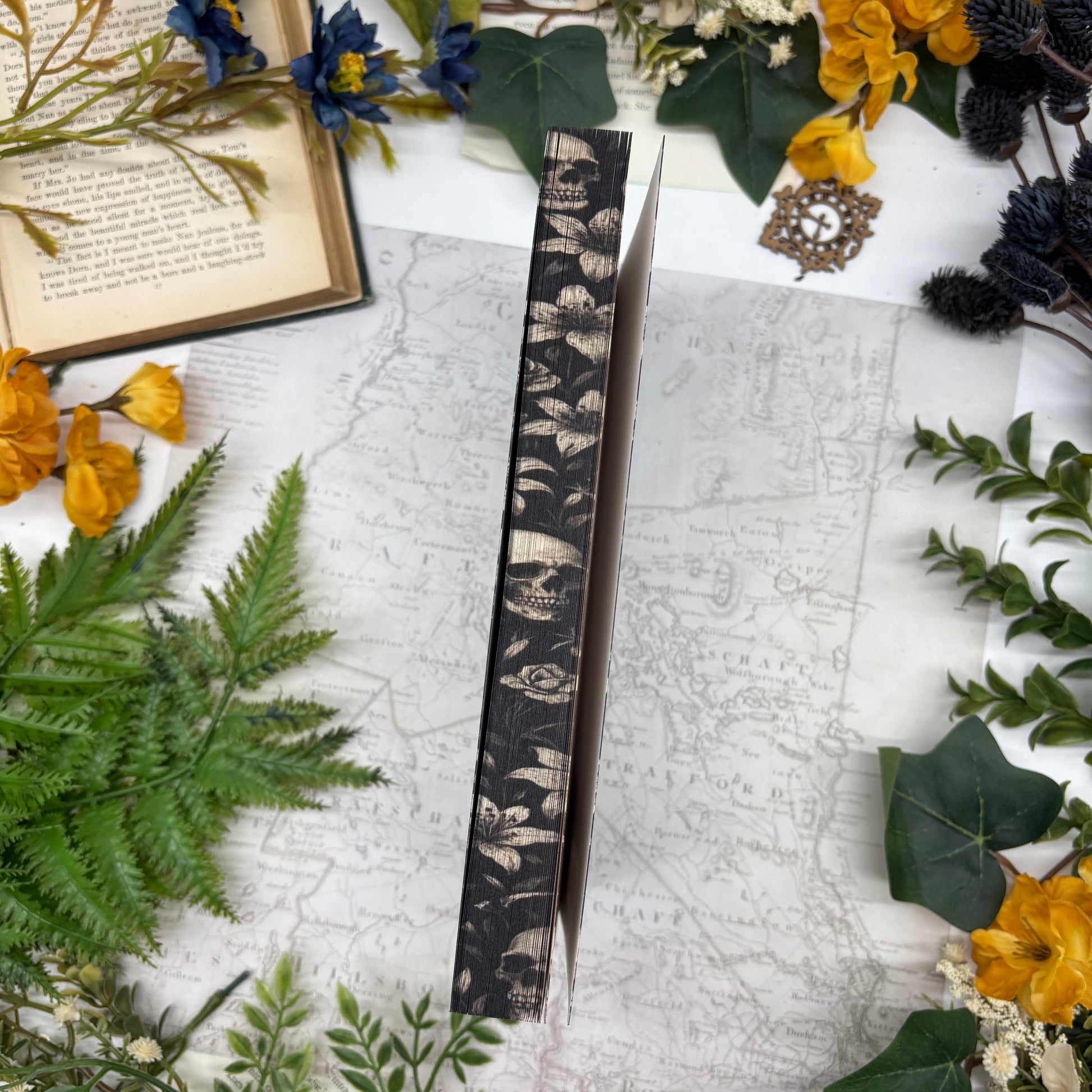 Dark romance thriller book with sprayed edges and handmade details