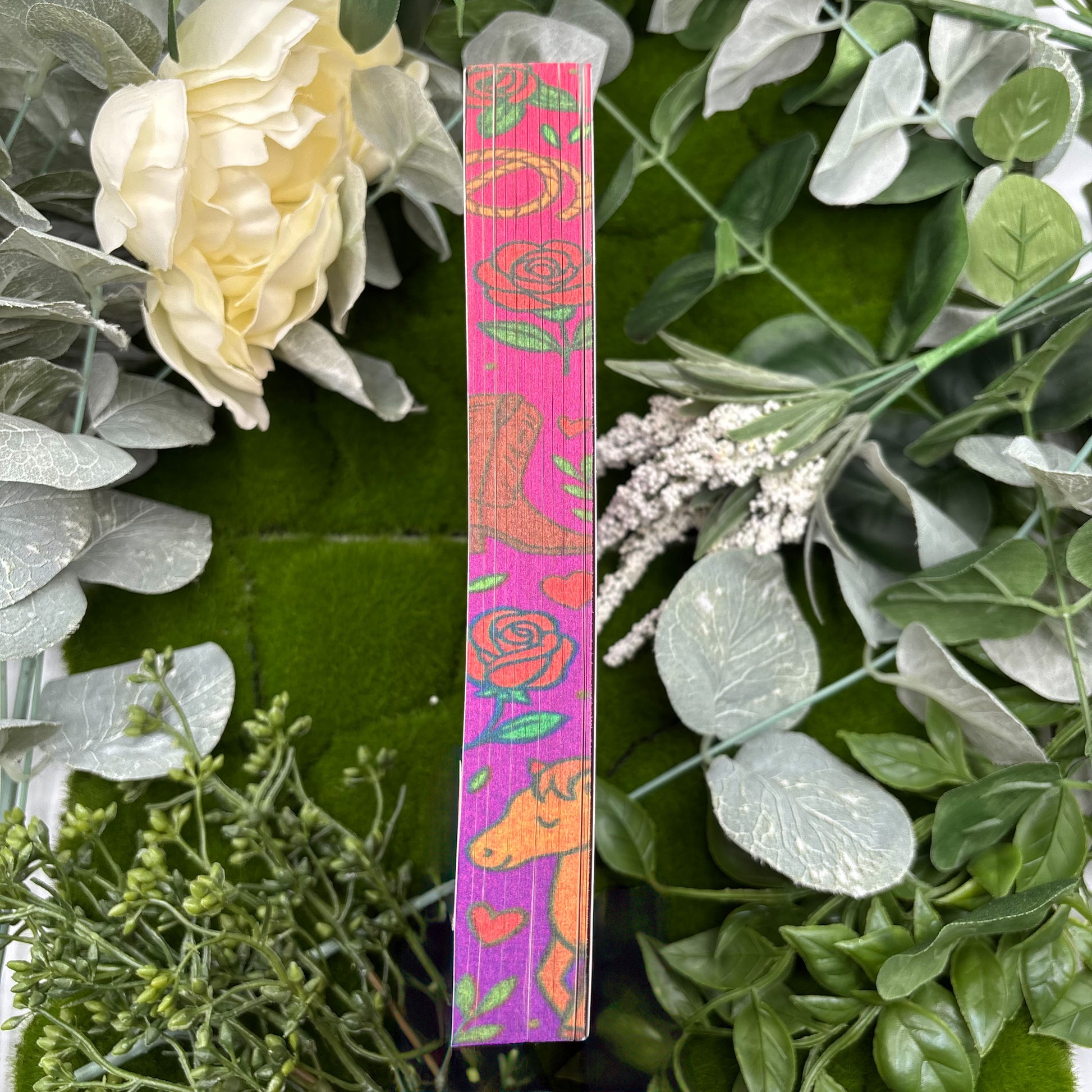 view of Wild and Wrangled paperback showing custom sprayed edges special edition